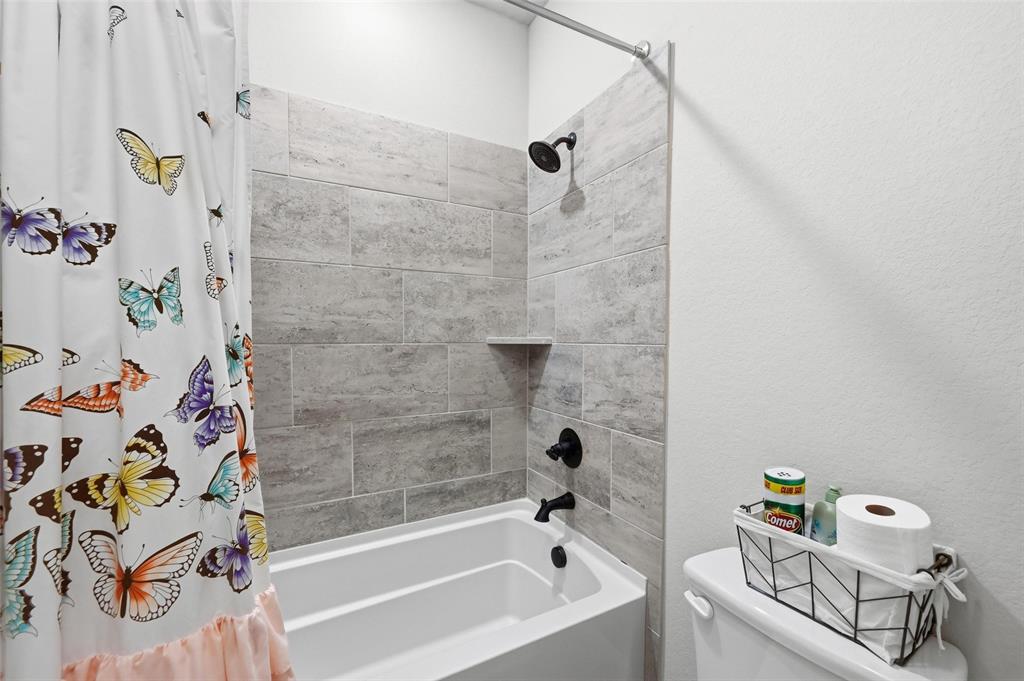 1421 Nighthawk Lane Mansfield, TX 76063 - Photo 32 of 40 a bathroom with a bathtub and shower