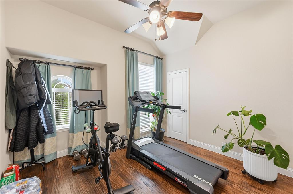 1421 Nighthawk Lane Mansfield, TX 76063 - Photo 35 of 40 a living room with furniture gym equipment and a window
