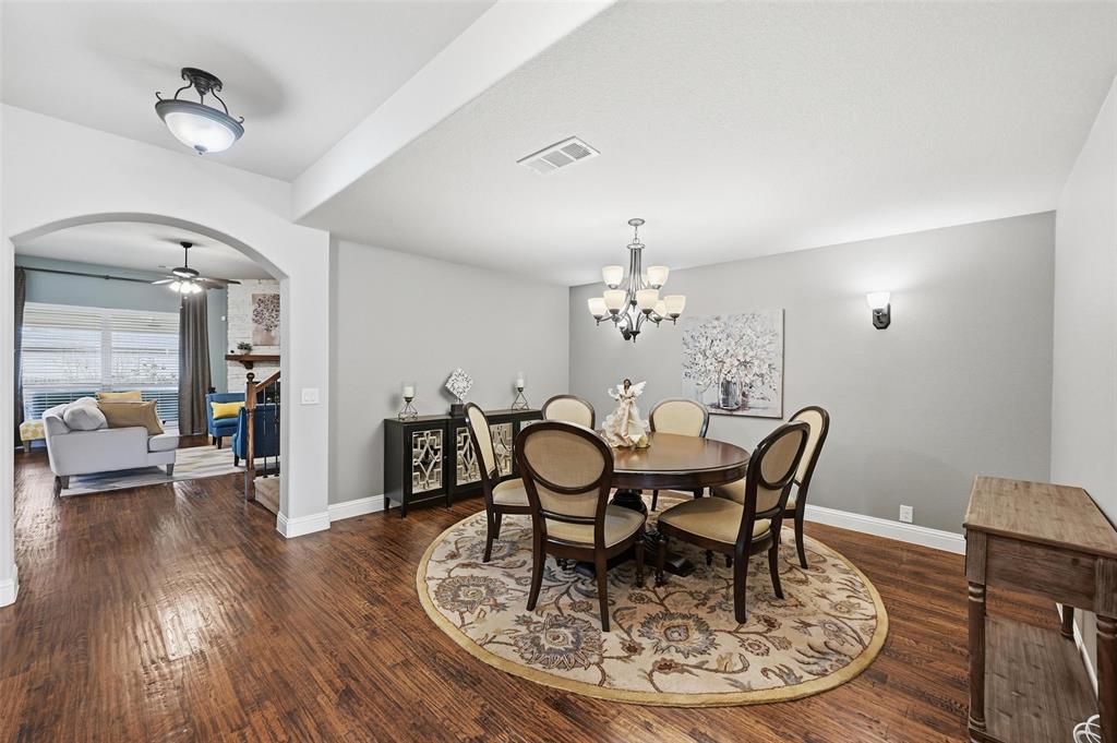 1421 Nighthawk Lane Mansfield, TX 76063 - Photo 5 of 40 a view of a dining room with furniture wooden floor and chandelier