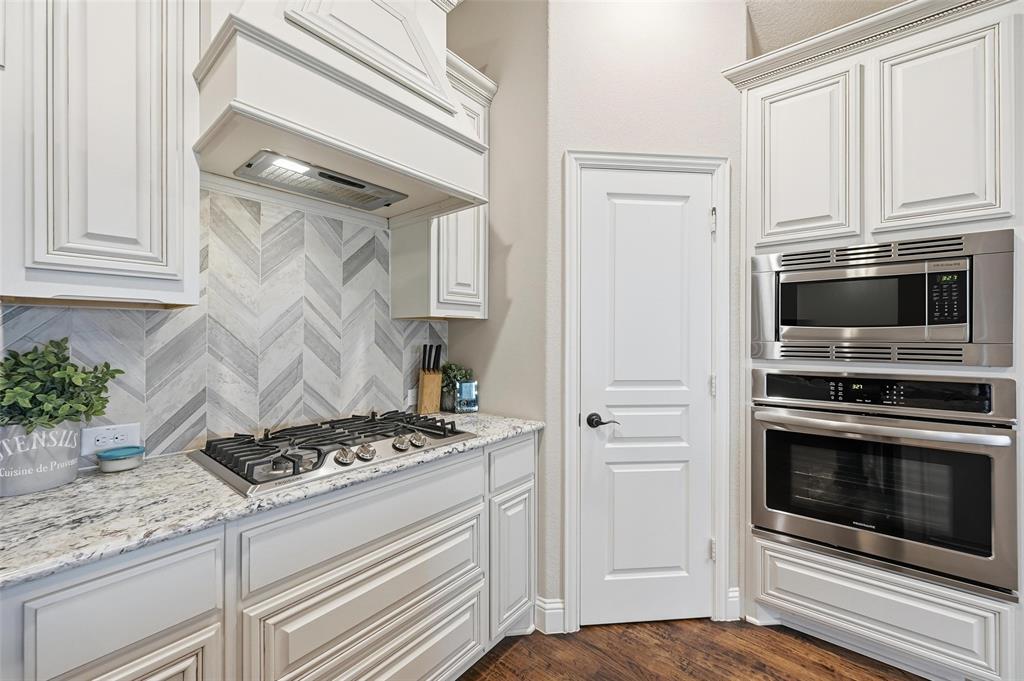 1421 Nighthawk Lane Mansfield, TX 76063 - Photo 10 of 40 a kitchen with white cabinets and appliances