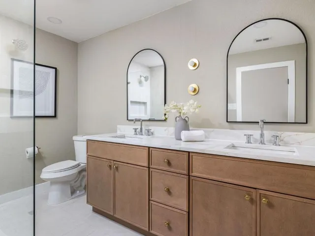 a bathroom with a toilet sink and mirror
