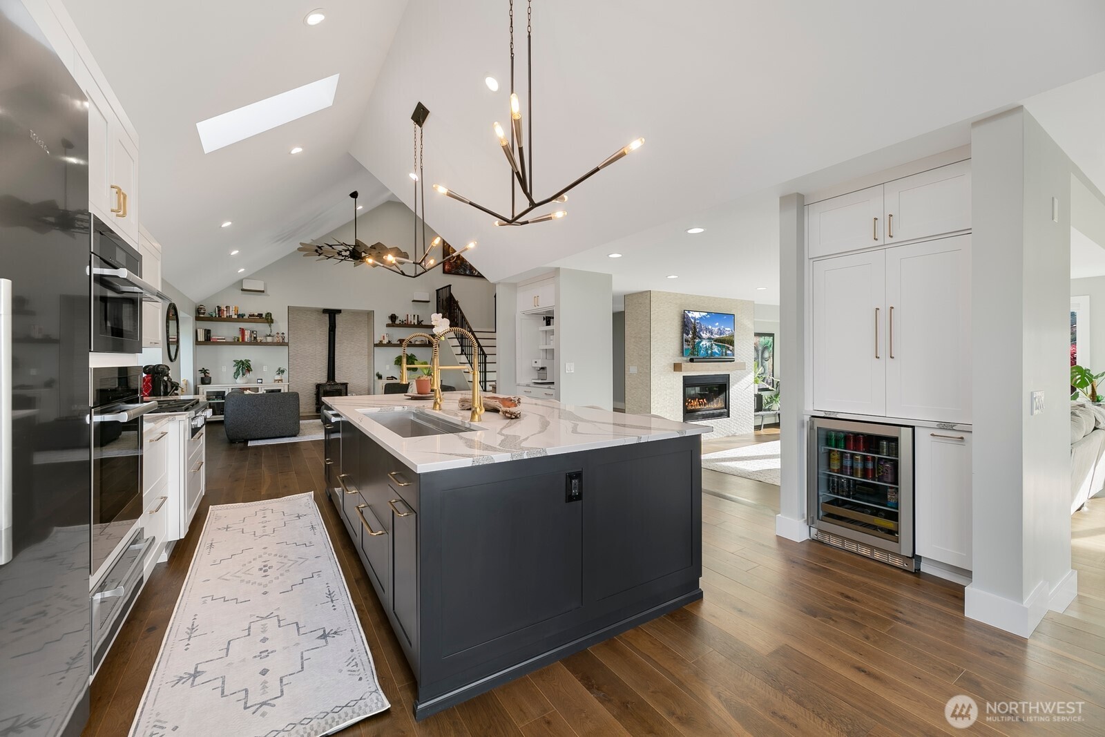 6625 136th Place Southwest Edmonds, WA 98026 - Photo 12 of 40 a kitchen with stainless steel appliances granite countertop a sink a stove and a wooden floors