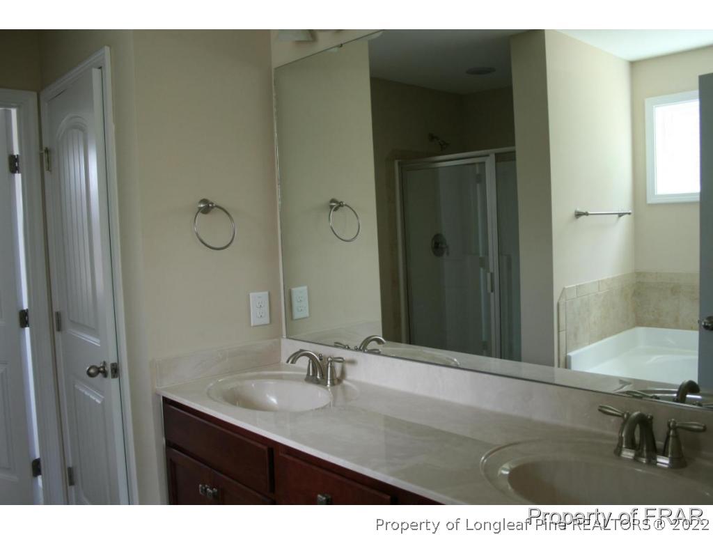 157 Shellbark Drive Spring Lake, NC 28390 - Photo 11 of 17 a bathroom with a sink and mirror