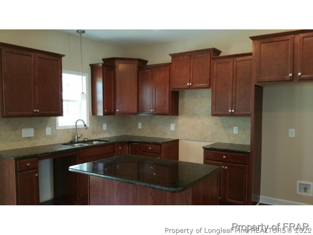 157 Shellbark Drive Spring Lake, NC 28390 - Photo 5 of 17 a kitchen with stainless steel appliances a sink dishwasher and cabinets with wooden floor