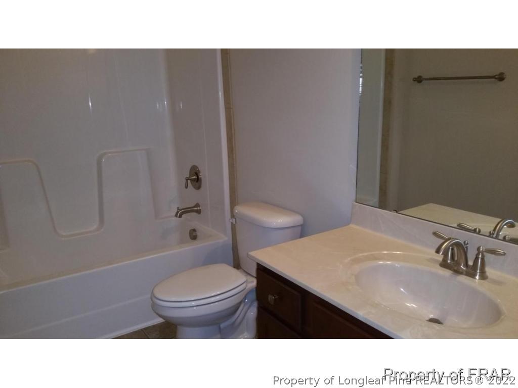 157 Shellbark Drive Spring Lake, NC 28390 - Photo 9 of 17 a bathroom with a sink a toilet and shower