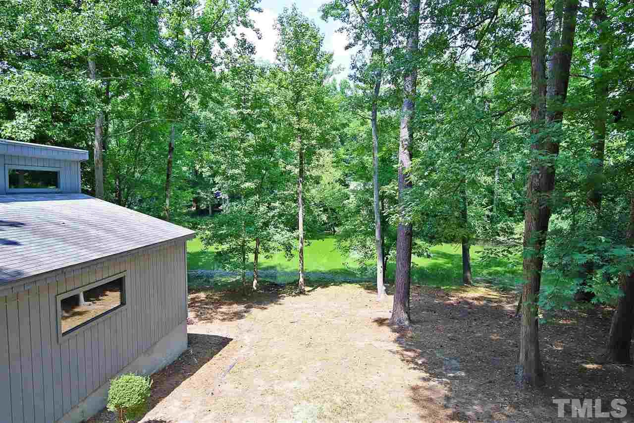 3317 Timberlake Road Raleigh, NC 27604 - Photo 22 of 30 a backyard of a house with lots of green space