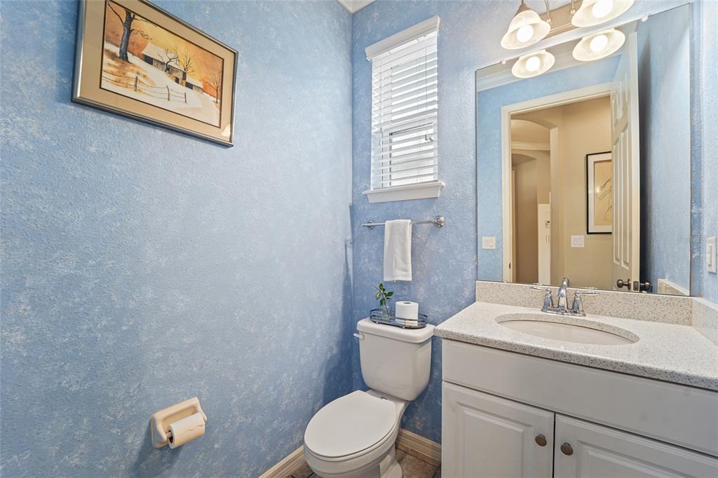 8903 Arabella Lane Seminole, FL 33777 - Photo 17 of 47 a bathroom with a toilet sink vanity and mirror
