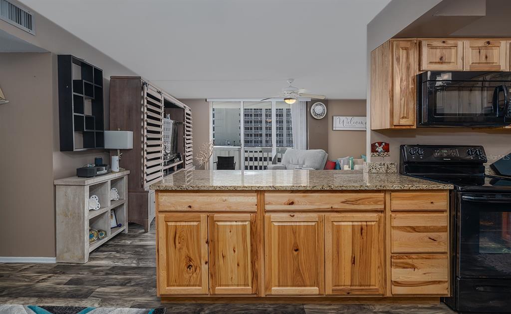 2800 North Atlantic Avenue, Unit 712 Daytona Beach, FL 32118 - Photo 12 of 20 a kitchen with granite countertop a stove and a sink