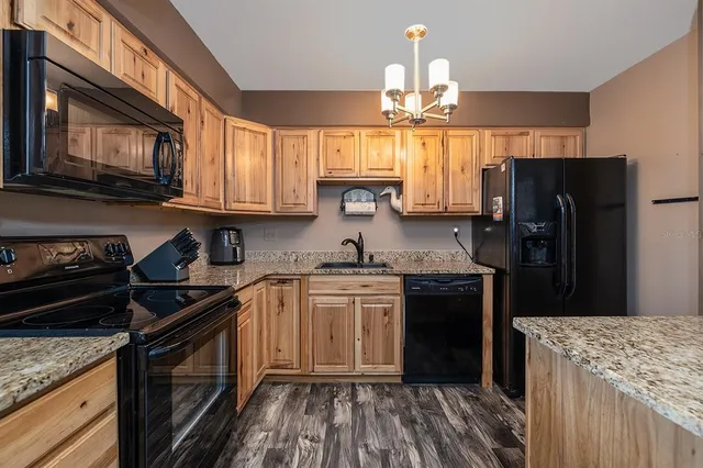 a kitchen with a sink stove and refrigerator