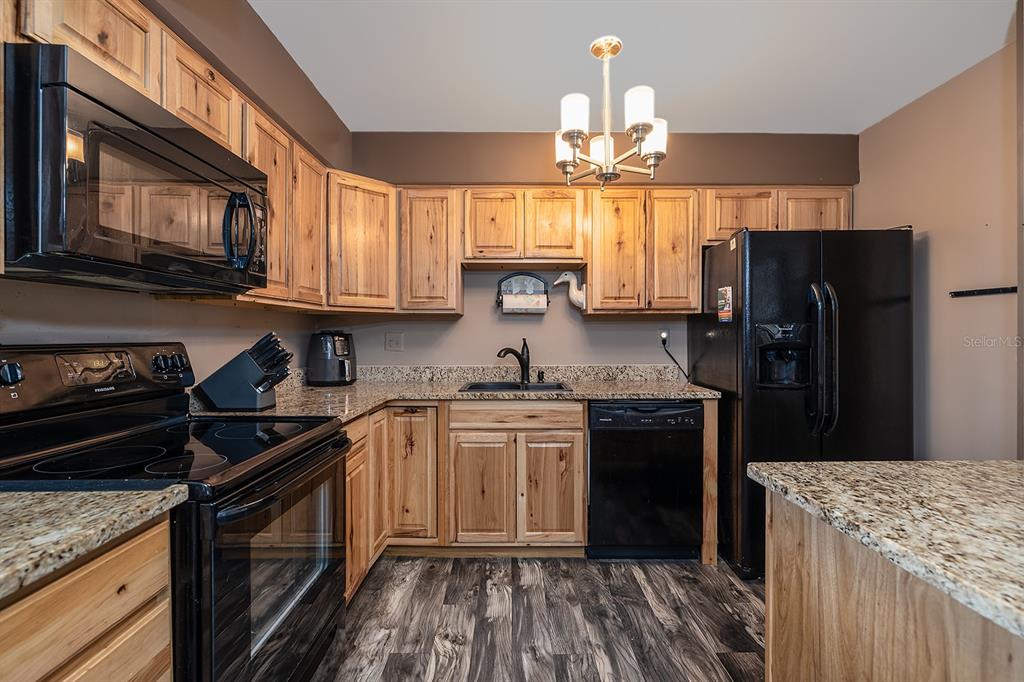2800 North Atlantic Avenue, Unit 712 Daytona Beach, FL 32118 - Photo 2 of 20 a kitchen with a sink stove and refrigerator