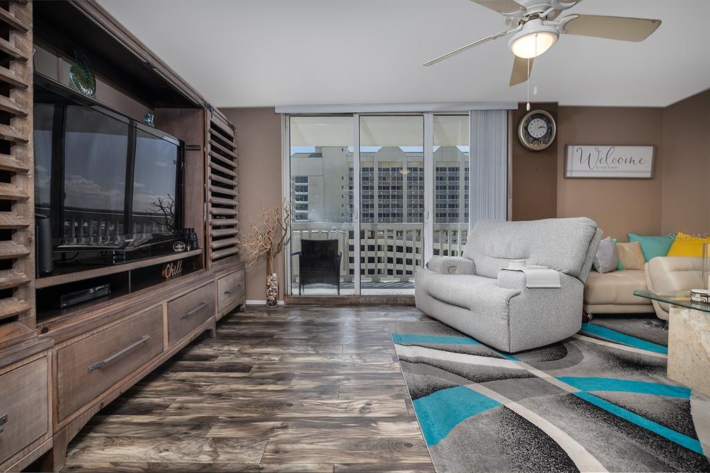 2800 North Atlantic Avenue, Unit 712 Daytona Beach, FL 32118 - Photo 3 of 20 a living room with furniture and a flat screen tv