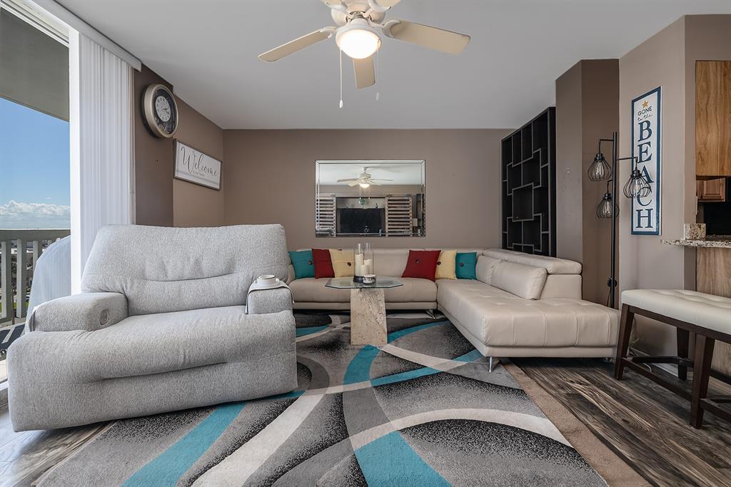 2800 North Atlantic Avenue, Unit 712 Daytona Beach, FL 32118 - Photo 6 of 20 a living room with furniture and a chandelier