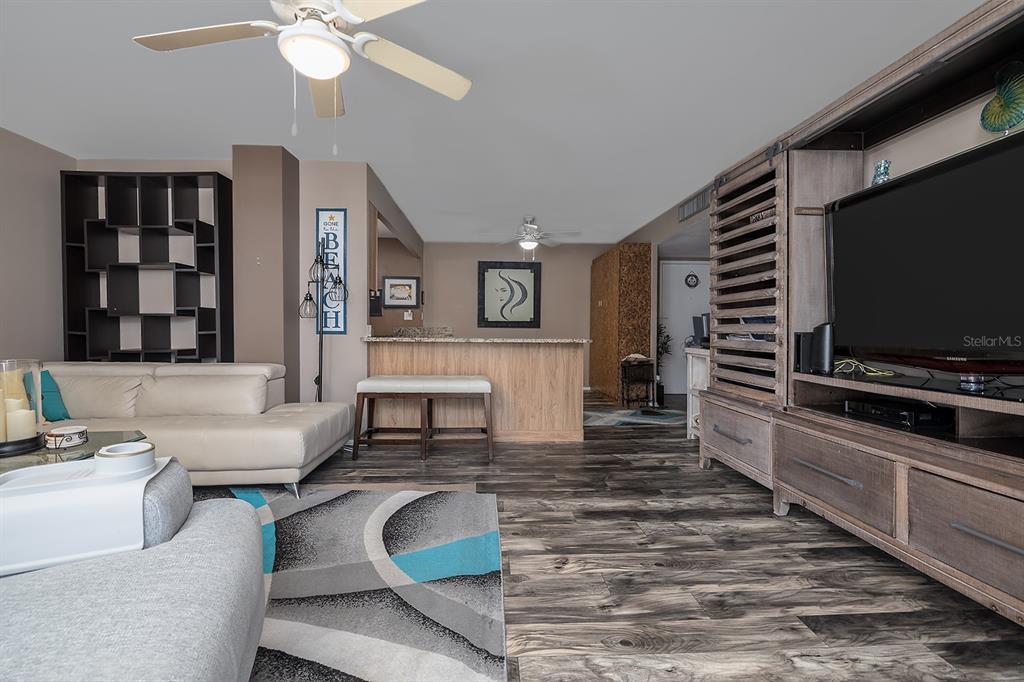 2800 North Atlantic Avenue, Unit 712 Daytona Beach, FL 32118 - Photo 7 of 20 a living room with furniture and a flat screen tv