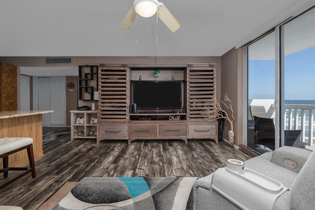 2800 North Atlantic Avenue, Unit 712 Daytona Beach, FL 32118 - Photo 8 of 20 a living room with furniture and a flat screen tv