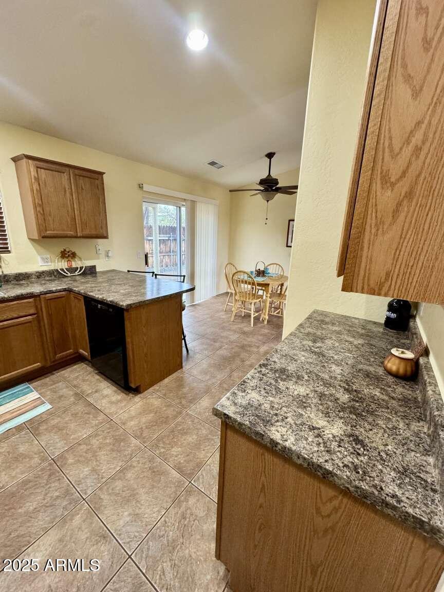4660 Monument Way Rimrock, AZ 86335 - Photo 12 of 33 a living room with kitchen island granite countertop furniture and a fireplace
