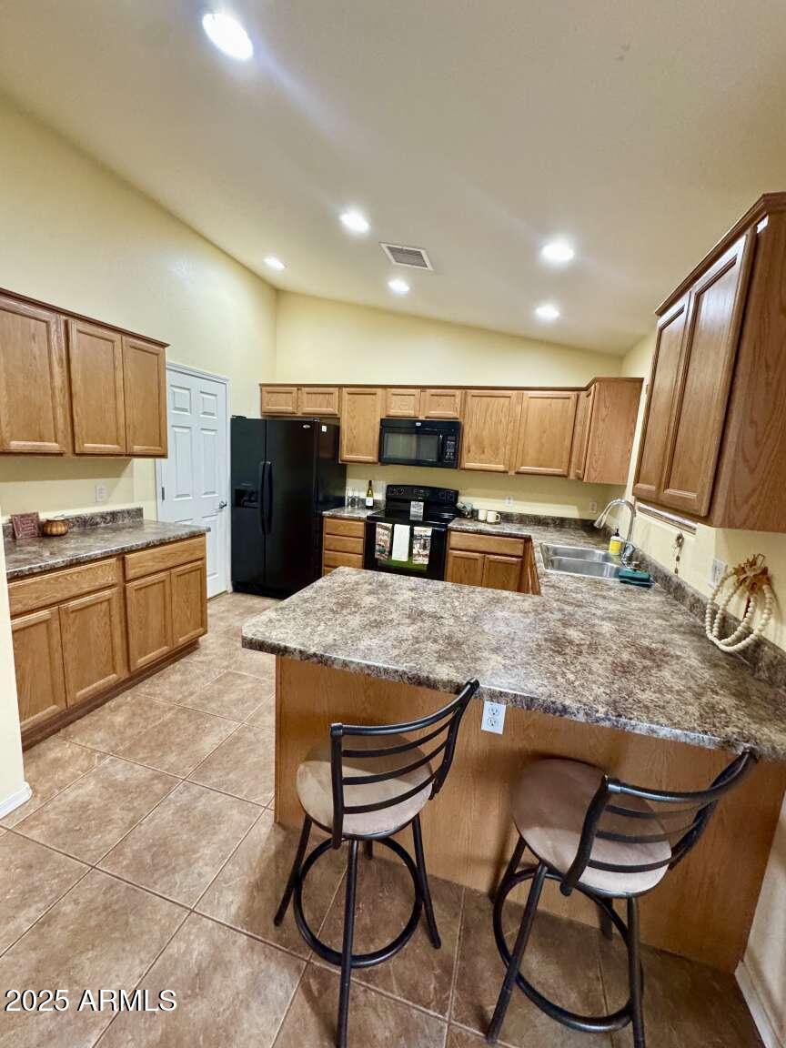 4660 Monument Way Rimrock, AZ 86335 - Photo 14 of 33 a kitchen with stainless steel appliances granite countertop table chairs sink and cabinets