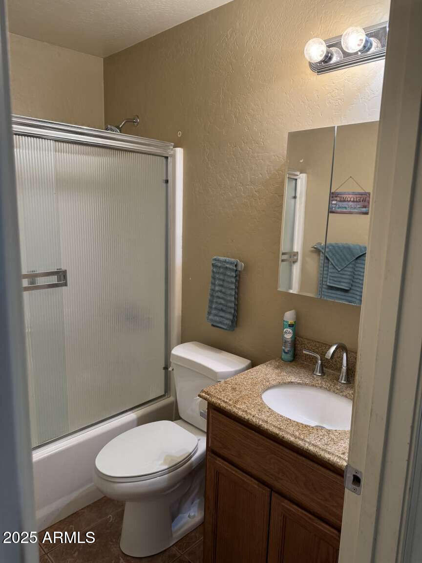 4660 Monument Way Rimrock, AZ 86335 - Photo 26 of 33 a bathroom with a granite countertop sink toilet and shower