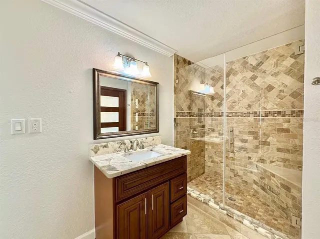 a bathroom with a sink vanity mirror and toilet