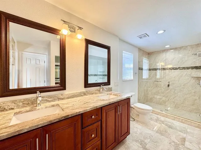 a bathroom with a tub shower and sink