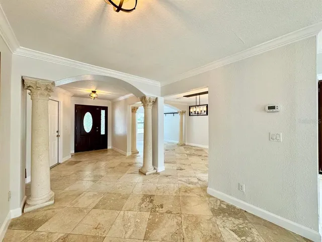 a view of a hallway with wooden shelves