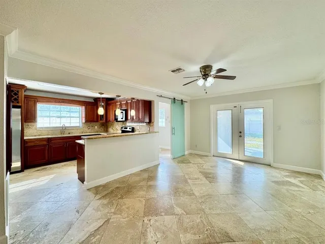 a view of kitchen with refrigerator and window