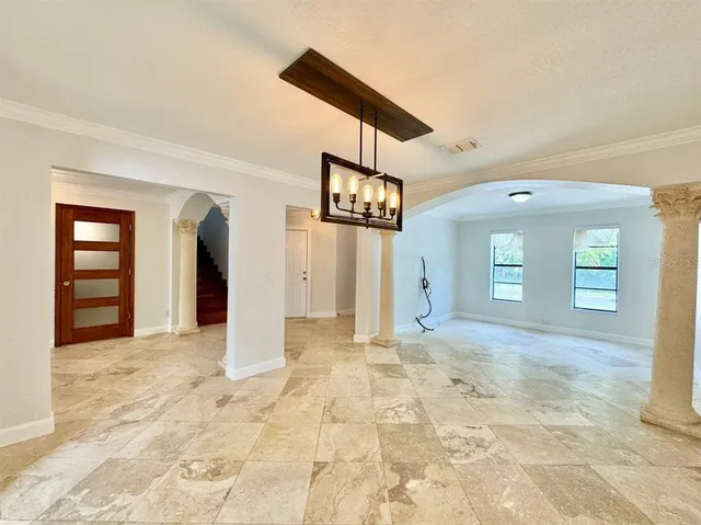 a view of a hallway with wooden floor and a living room