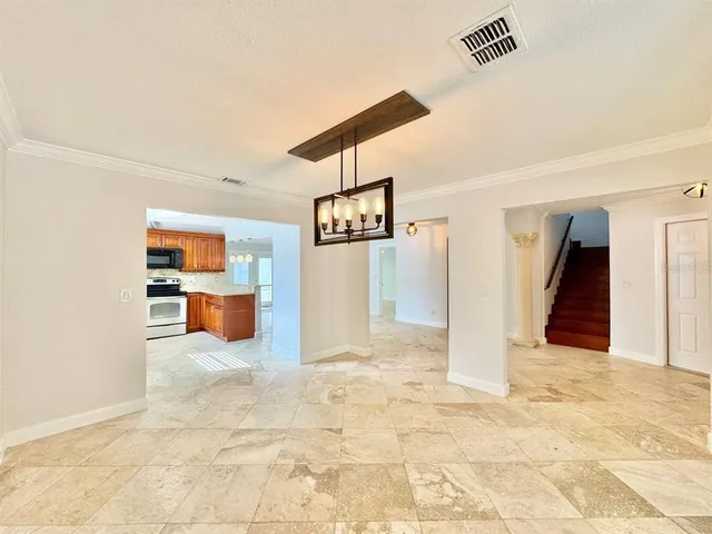 a view of a livingroom with wooden floor and a refrigerator