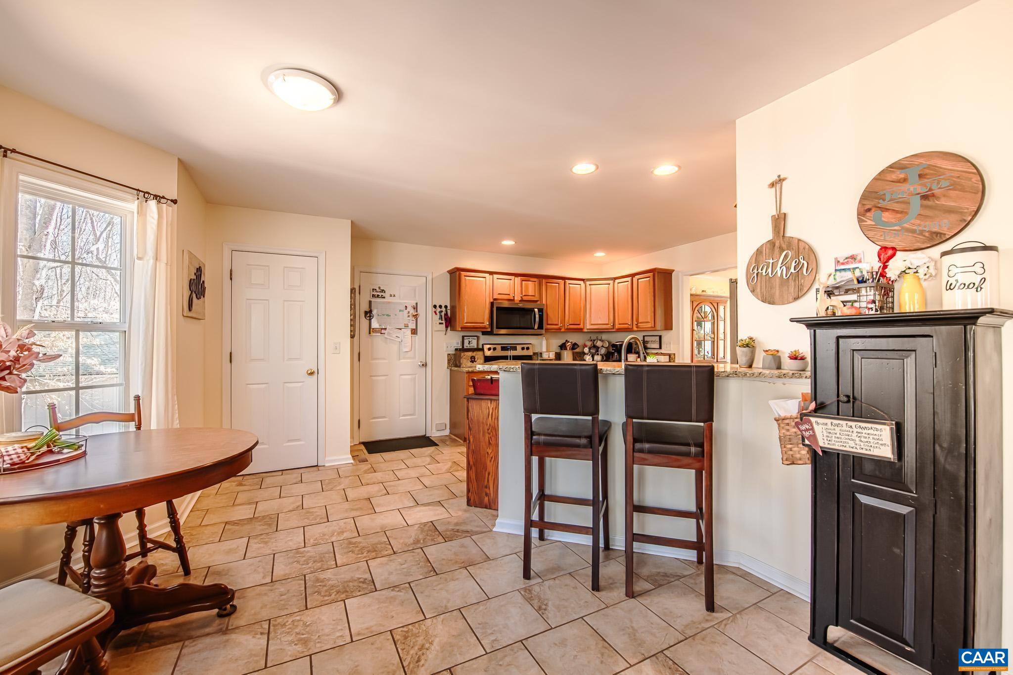 116 Riverside Drive Palmyra, VA 22963 - Photo 11 of 31 a living room with stainless steel appliances kitchen island granite countertop a stove a sink and a dining table