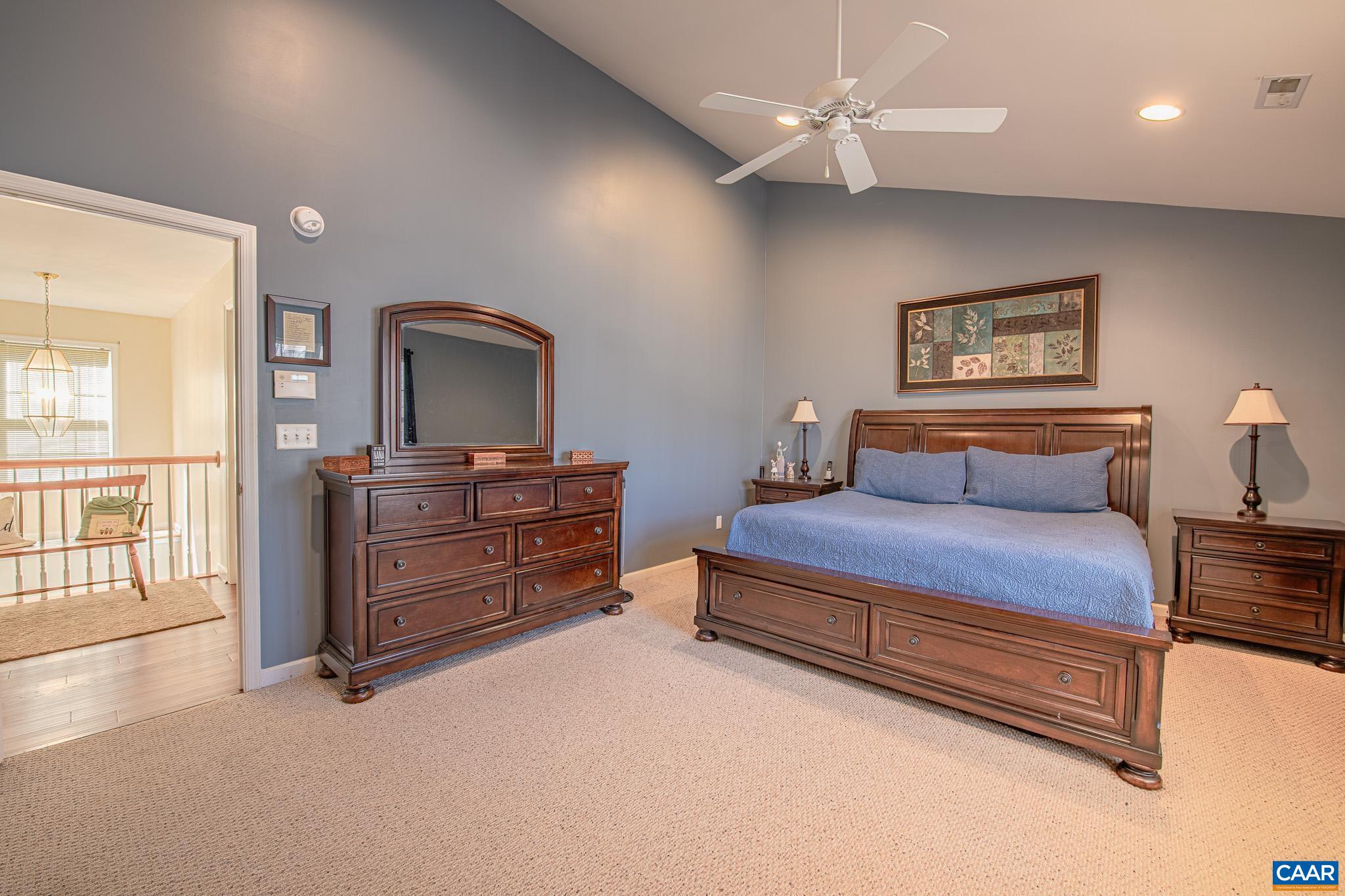 116 Riverside Drive Palmyra, VA 22963 - Photo 15 of 31 a spacious bedroom with a bed and a dresser with wooden floor