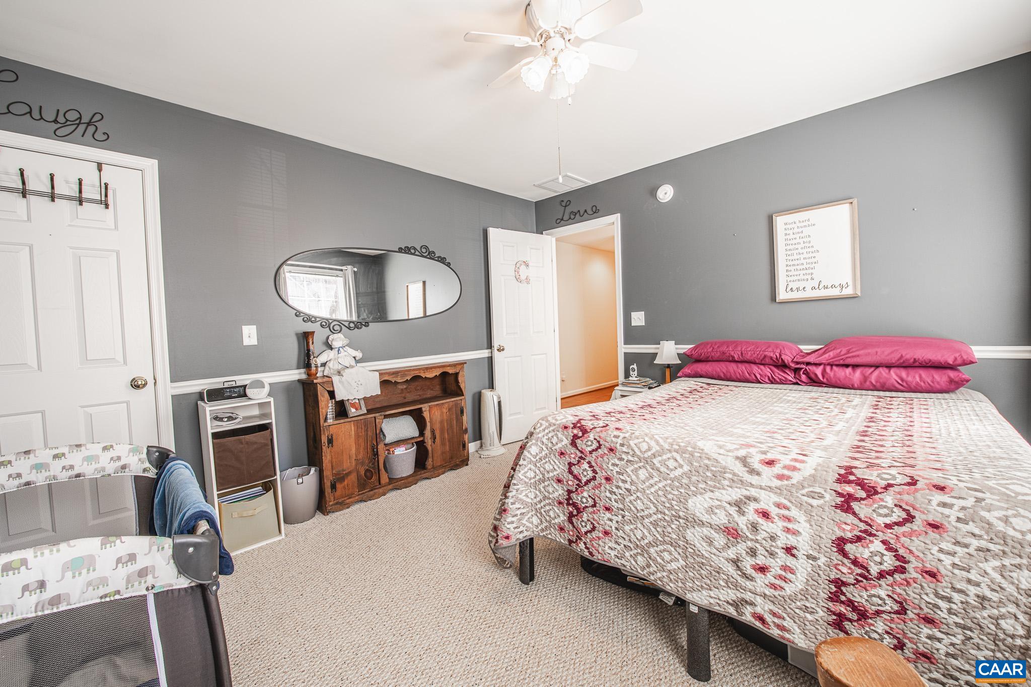 116 Riverside Drive Palmyra, VA 22963 - Photo 19 of 31 a bedroom with a bed and a flat tv screen on dresser