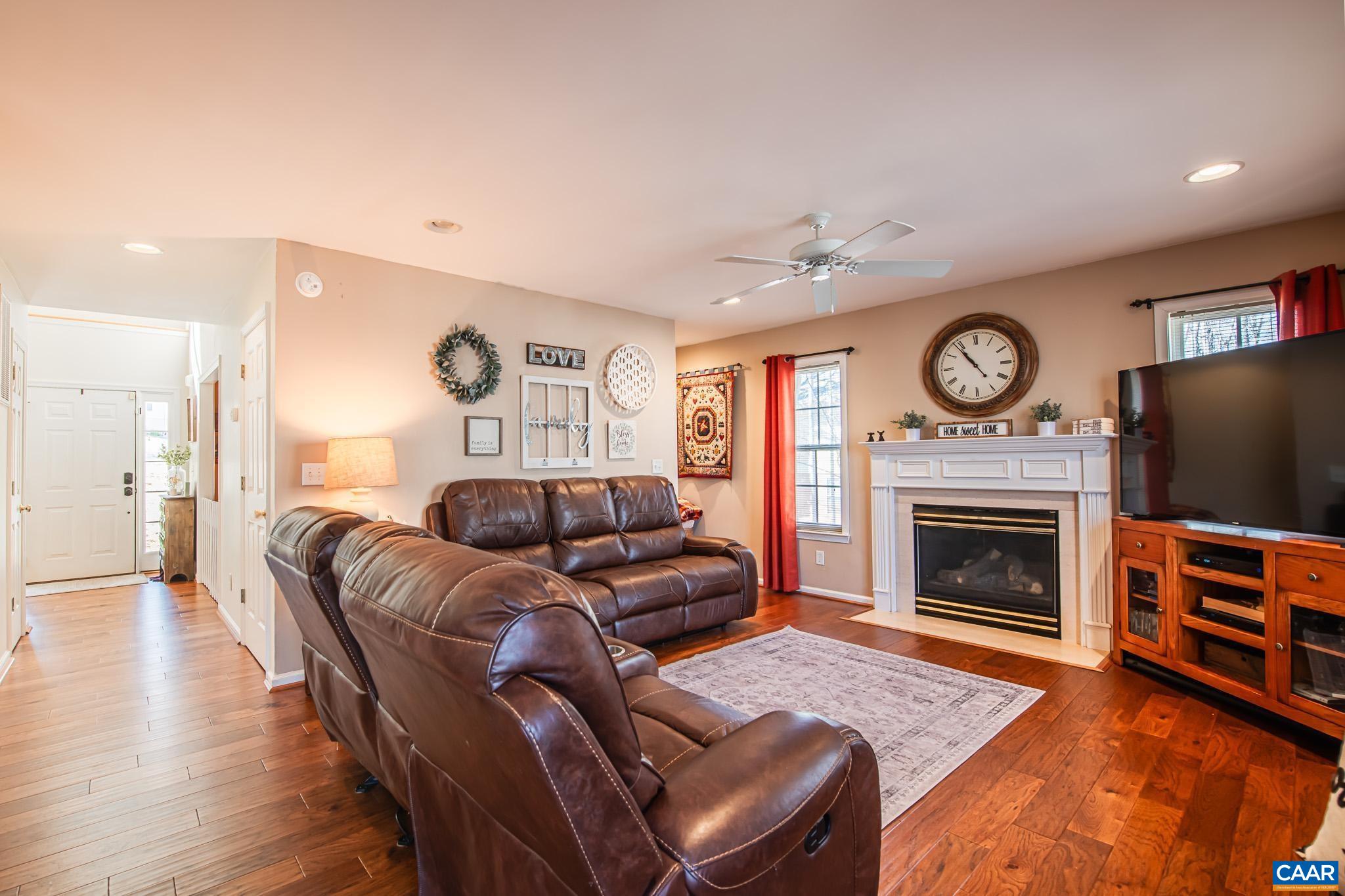 116 Riverside Drive Palmyra, VA 22963 - Photo 6 of 31 a living room with furniture a fireplace and wooden floor