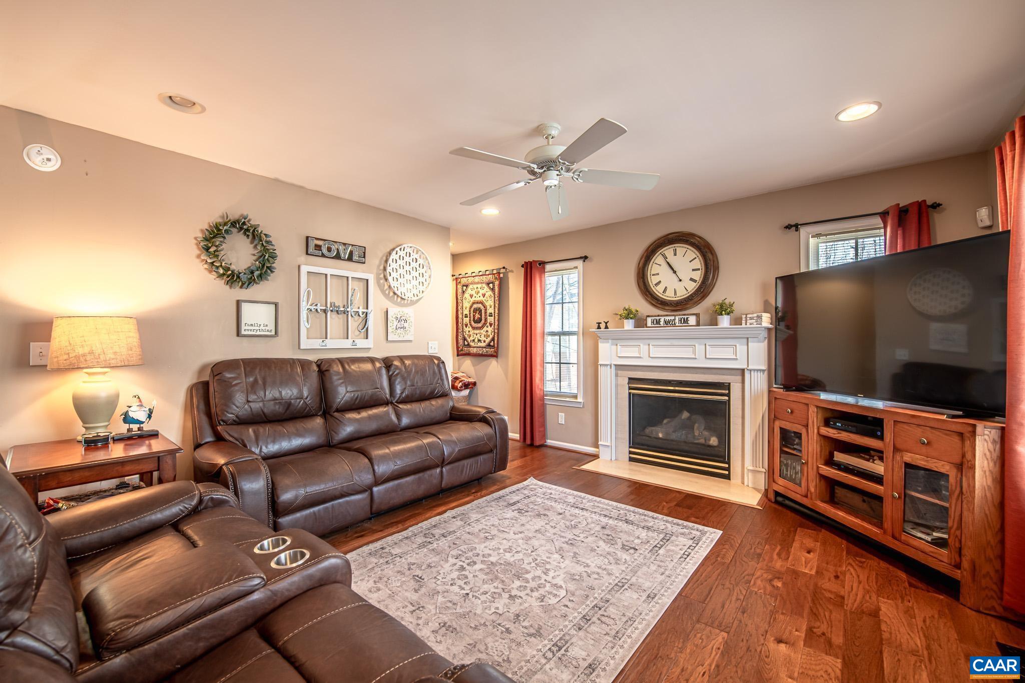 116 Riverside Drive Palmyra, VA 22963 - Photo 7 of 31 a living room with furniture a flat screen tv and a fireplace