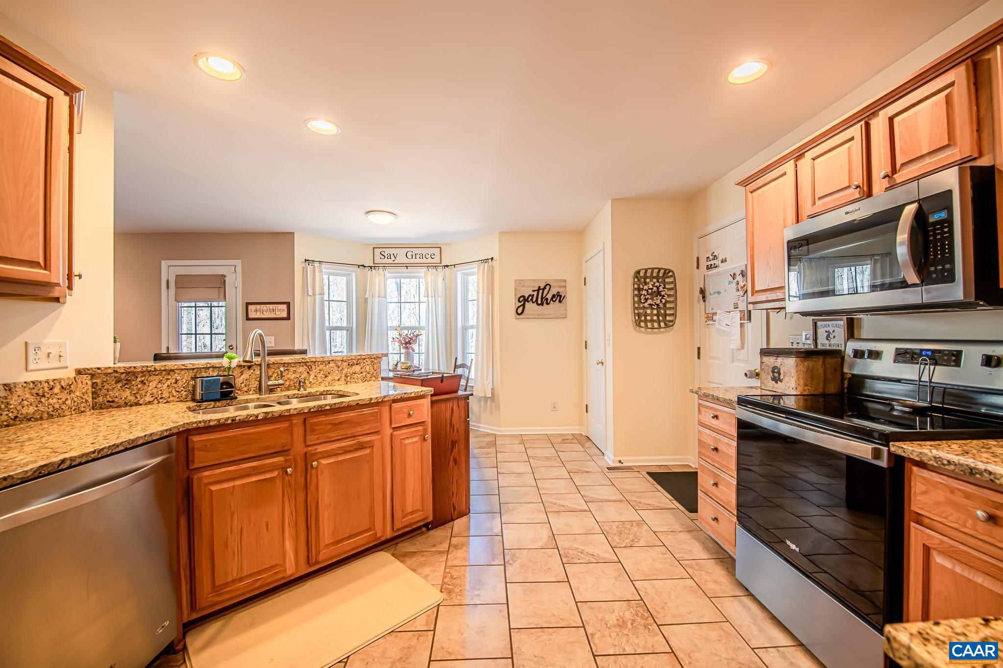 116 Riverside Drive Palmyra, VA 22963 - Photo 8 of 31 a large kitchen with stainless steel appliances granite countertop a sink and cabinets