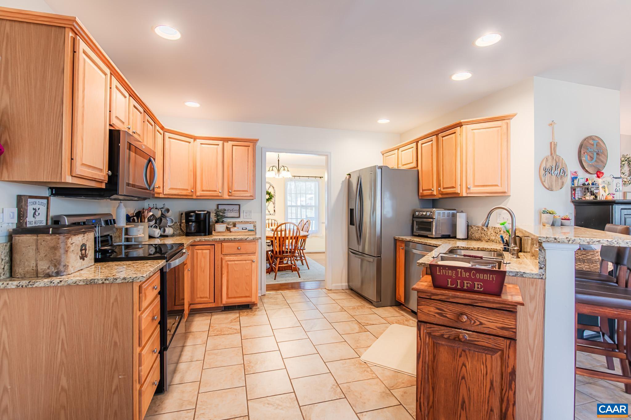 116 Riverside Drive Palmyra, VA 22963 - Photo 10 of 31 a kitchen with stainless steel appliances granite countertop a refrigerator and a stove top oven