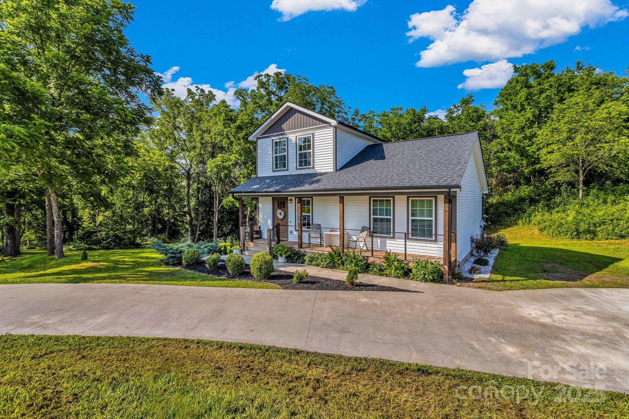 a front view of a house with a yard and outdoor seating
