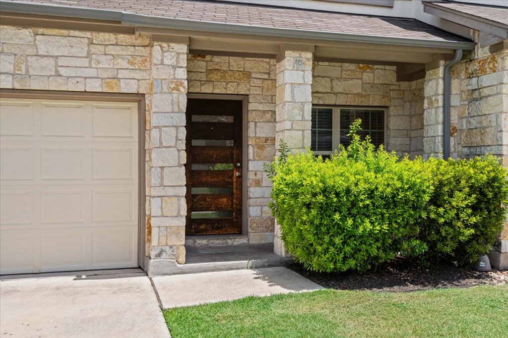 1502 Airedale Road, Unit 2502 Austin, TX 78748 - Photo 2 of 28 A welcoming stone facade with a rich wood entry door sets a charming tone.