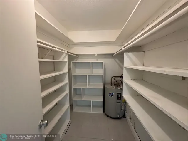 a bathroom with a granite countertop sink a mirror and a bathtub