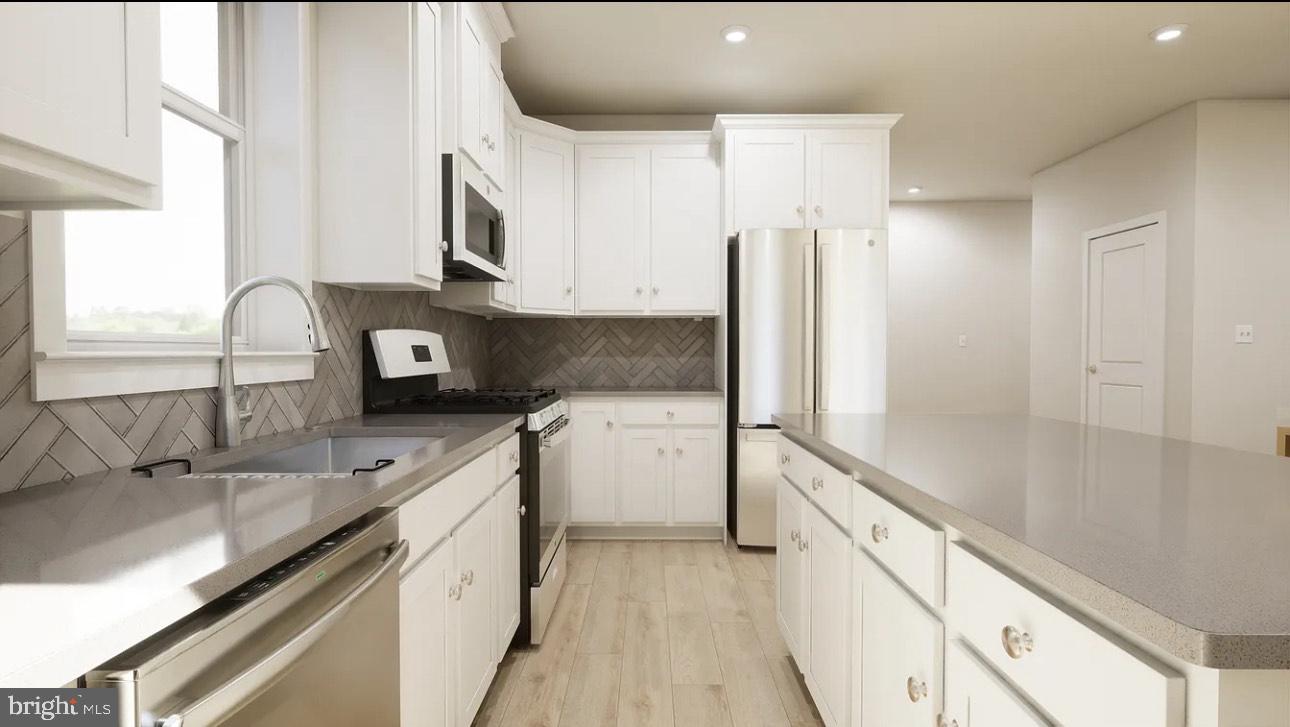 43312 Farringdon Square, Unit 215 Ashburn, VA 20148 - Photo 5 of 10 a kitchen with stainless steel appliances granite countertop a sink stove and refrigerator