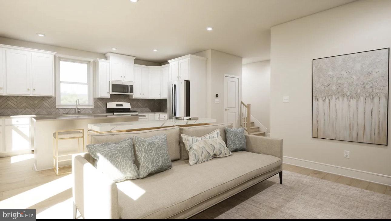 43312 Farringdon Square, Unit 215 Ashburn, VA 20148 - Photo 6 of 10 a living room with stainless steel appliances kitchen island granite countertop a couch and a view of living room