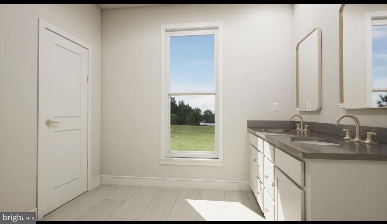 43312 Farringdon Square, Unit 215 Ashburn, VA 20148 - Photo 8 of 10 a bathroom with a granite countertop sink and a mirror