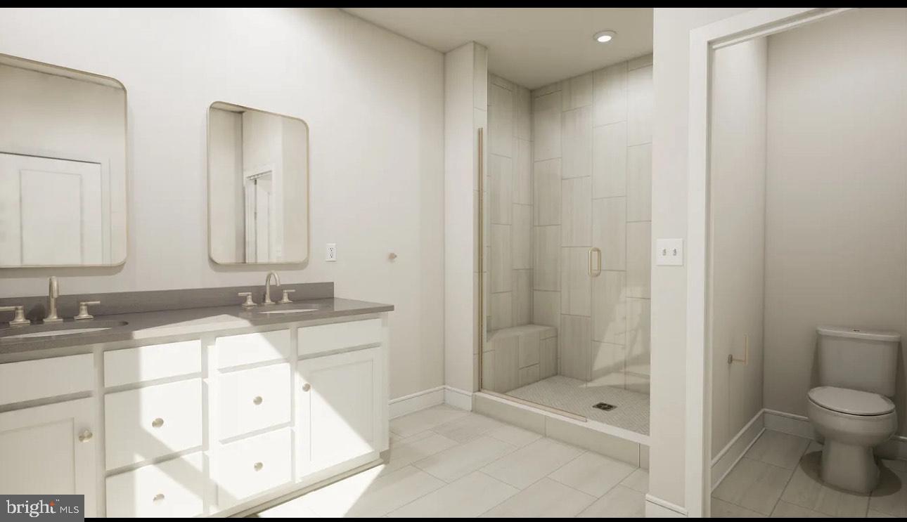 43312 Farringdon Square, Unit 215 Ashburn, VA 20148 - Photo 10 of 10 a bathroom with a bathtub shower sink mirror and toilet