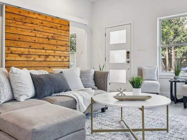 a living room with furniture and wooden floor