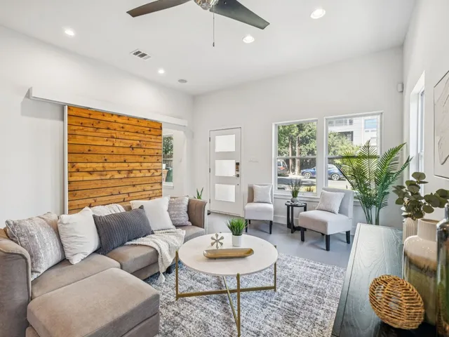 a living room with furniture and a large window