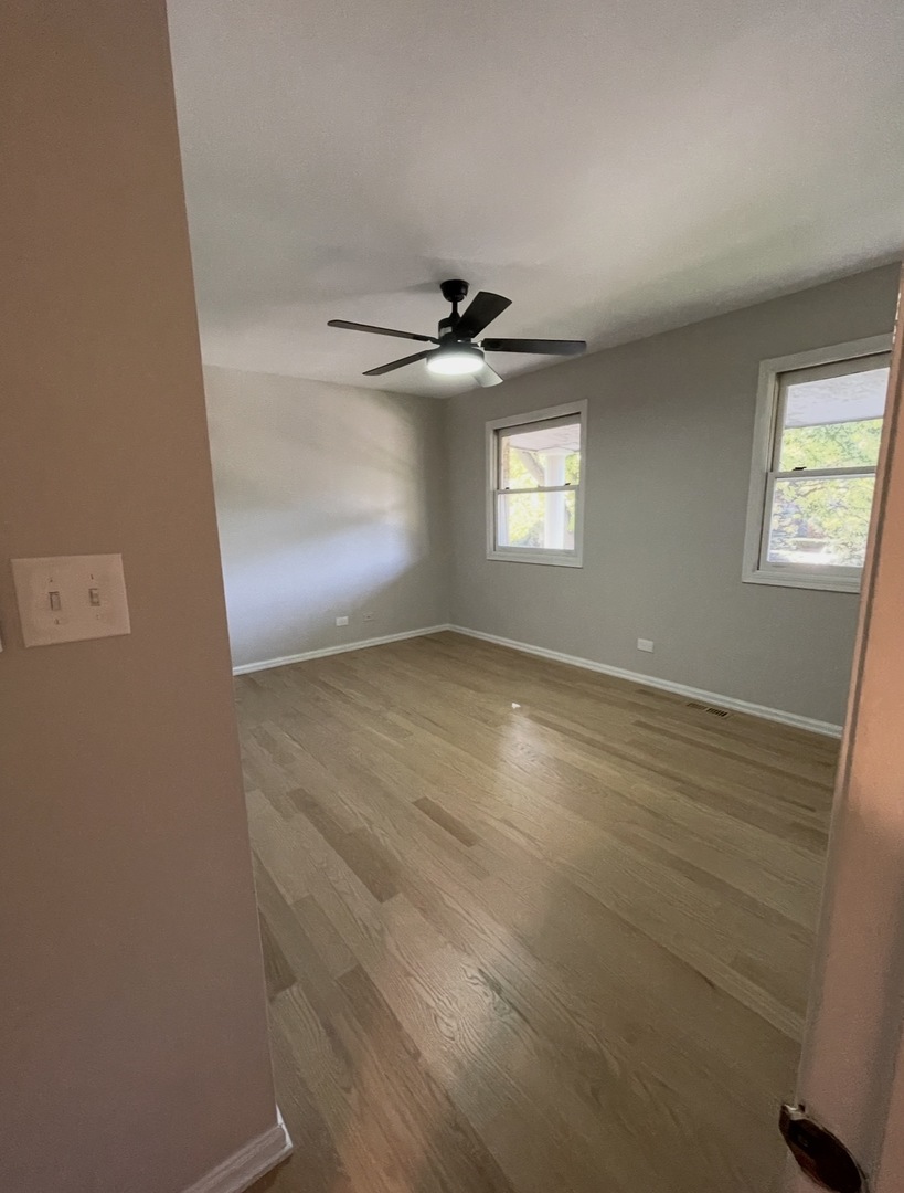1703 Winnetka Road Northfield, IL 60093 - Photo 9 of 10 an empty room with windows and fan