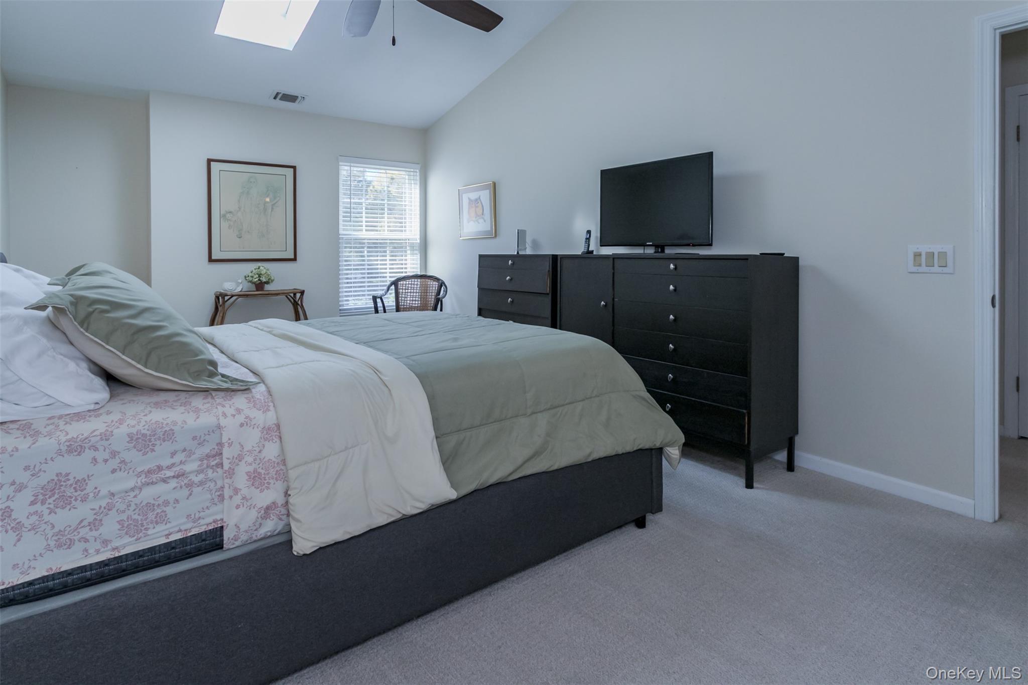 9 Olde Wagon Road Warwick, NY 10990 - Photo 12 of 23 a bedroom with a bed and a flat tv screen on dresser