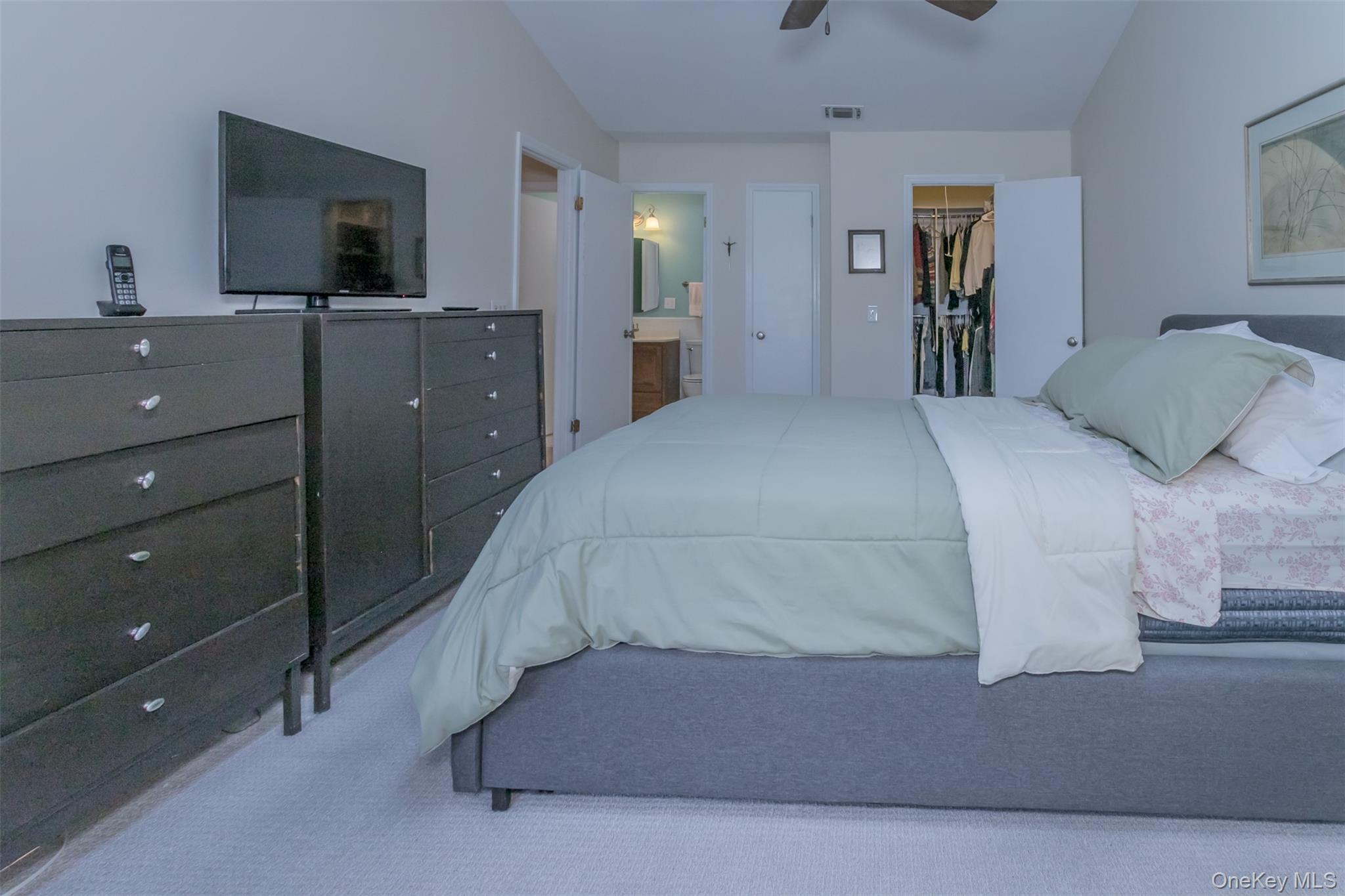 9 Olde Wagon Road Warwick, NY 10990 - Photo 13 of 23 a spacious bedroom with a bed and a flat screen tv