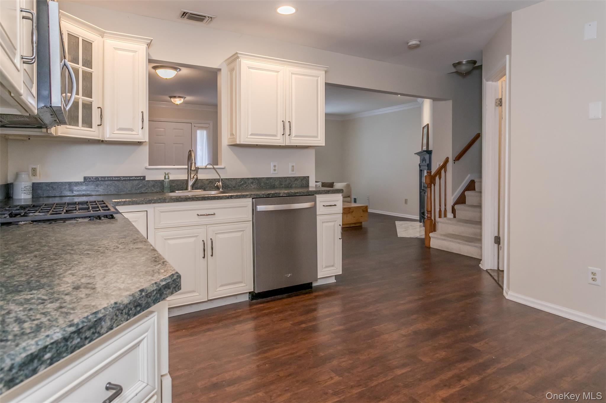 9 Olde Wagon Road Warwick, NY 10990 - Photo 7 of 23 a kitchen with granite countertop a sink a stove and cabinets