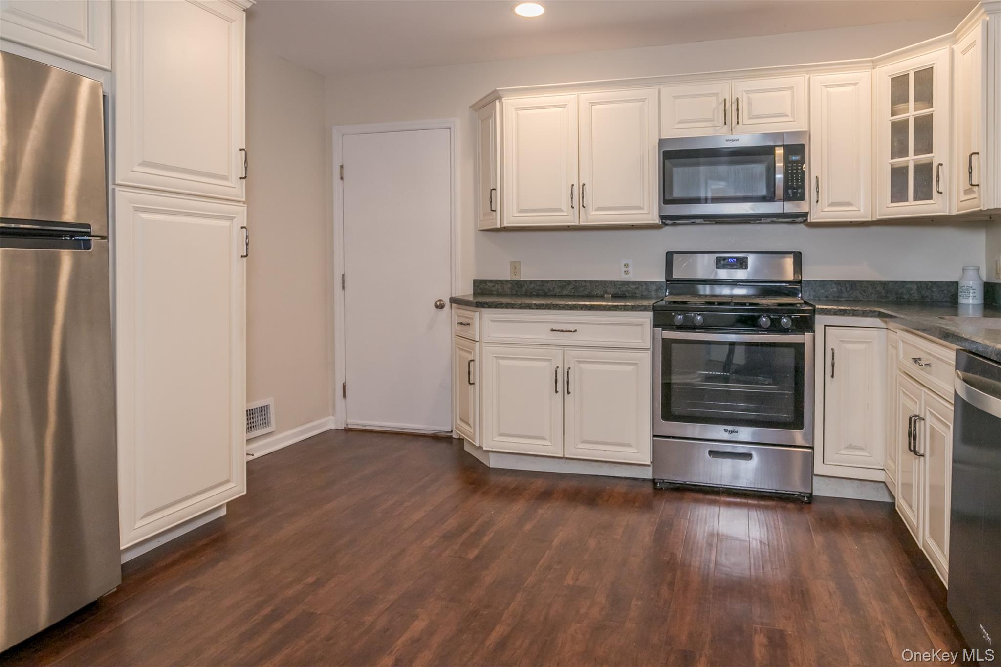 9 Olde Wagon Road Warwick, NY 10990 - Photo 8 of 23 a kitchen with stainless steel appliances granite countertop a stove a refrigerator and a microwave