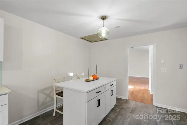 an empty room with wooden floor and ceiling fan