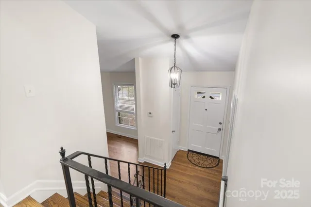 a kitchen with stainless steel appliances wooden floor dining table and chairs